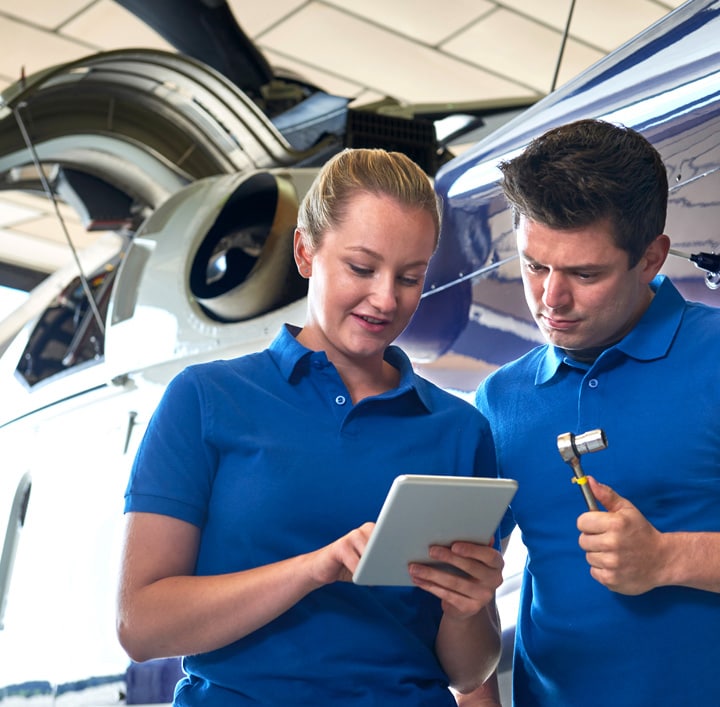 Two people looking at a tablet