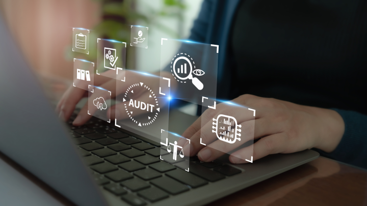 Hands typing on a laptop keyboard with glowing digital security icons floating above