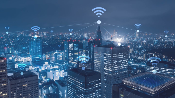 Wifi symbol hovering over buildings within a city 