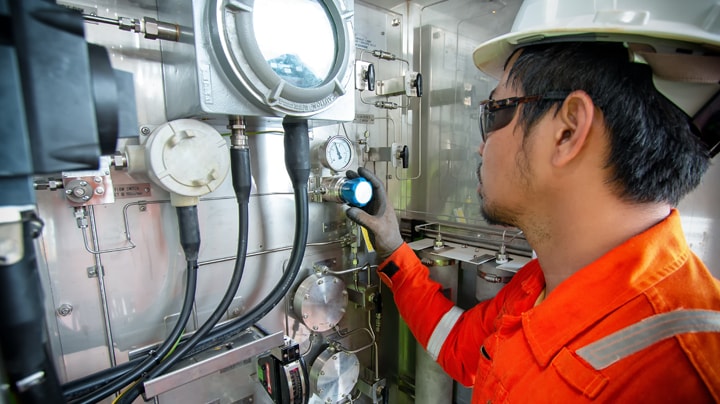 A person in safety gear working inside a submarine