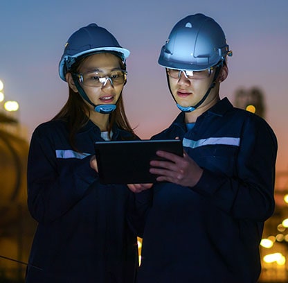 Two people looking at a tablet in the early morning