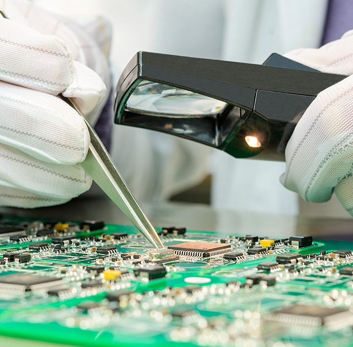 A person fixing a circuit board