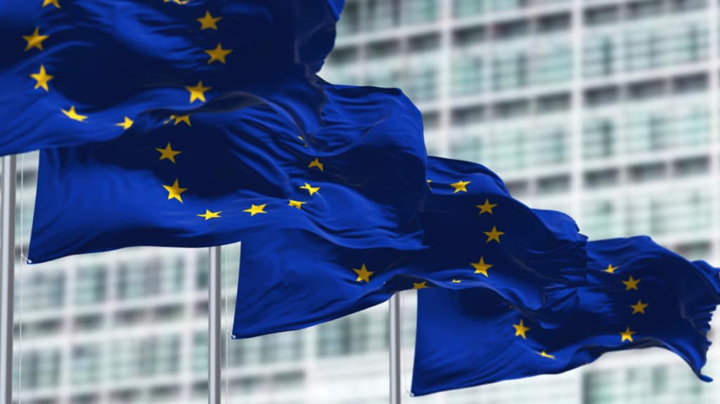 4 EU flags flying in front of a building